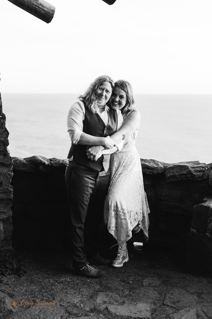 A couple pose for an elopement portrait at Sunset along the Oregon Coast. 