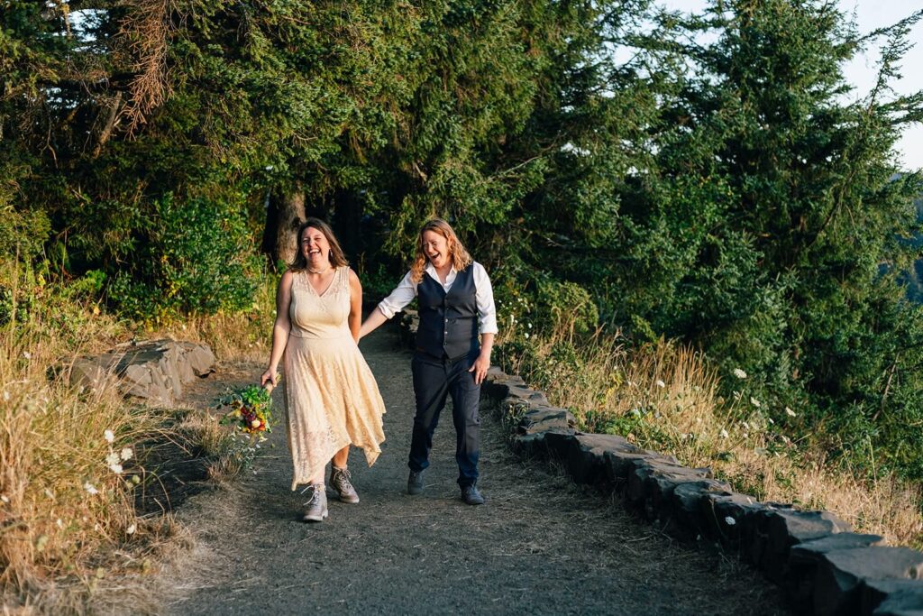 A Pacific Northwest couple walks along a hiking trail during their Oregon Coast elopement at Sunset.