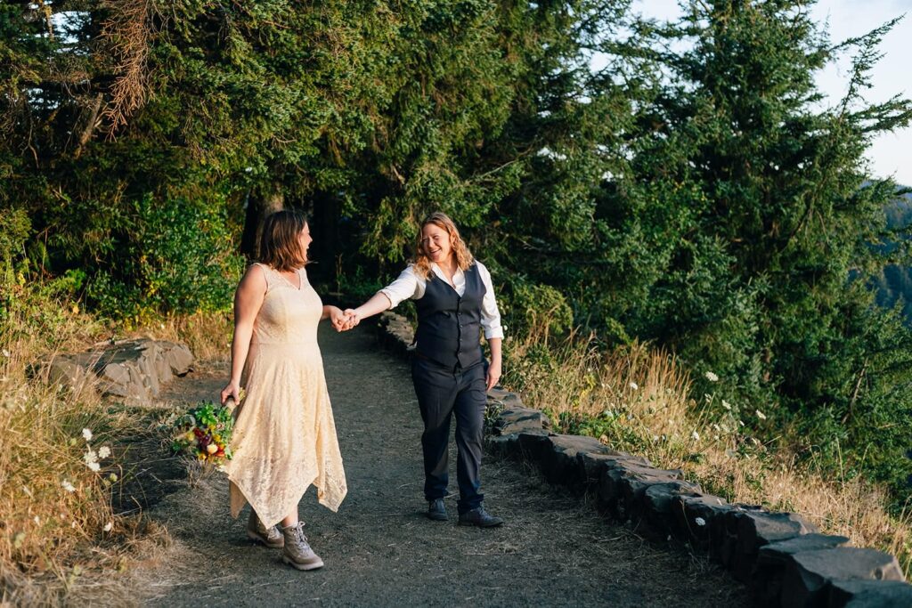 A couple holds hands on a trail at Cape Perpetua Scenic Area. 