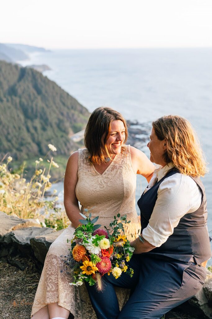 A couple admires one another during their hiking elopement at an overlook in Cape Perpetua Scenic Area. 