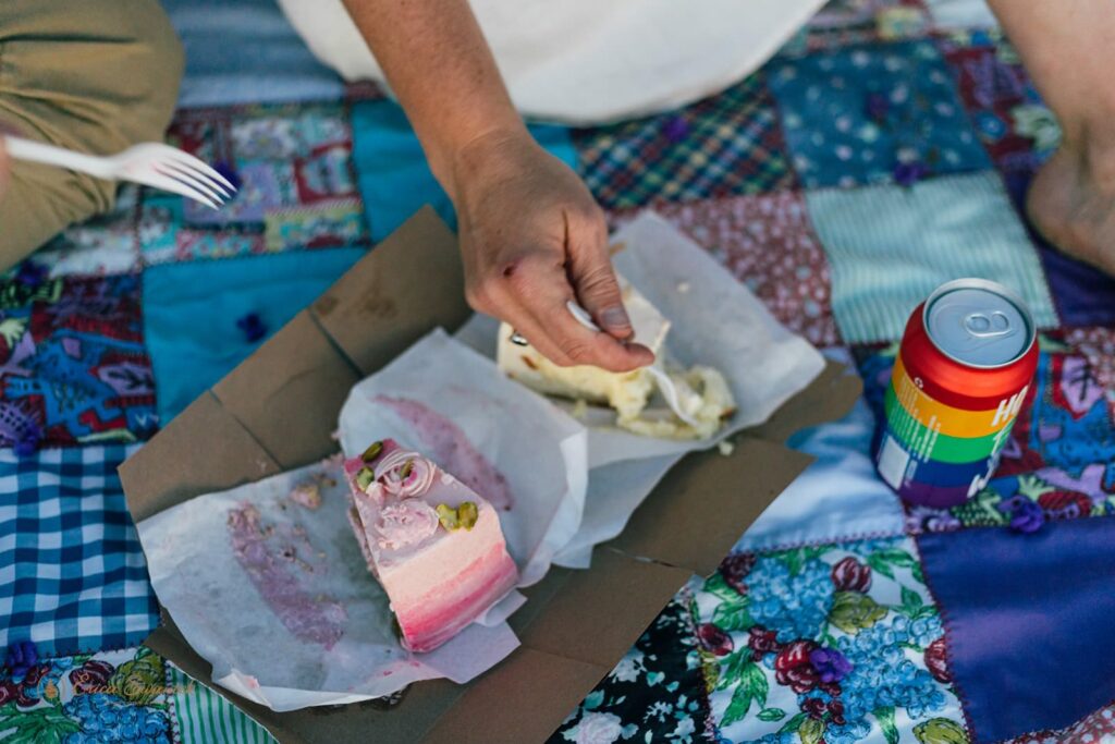 Two slices of wedding cake on a picnic blanket at Neptune Beach in Oregon. 