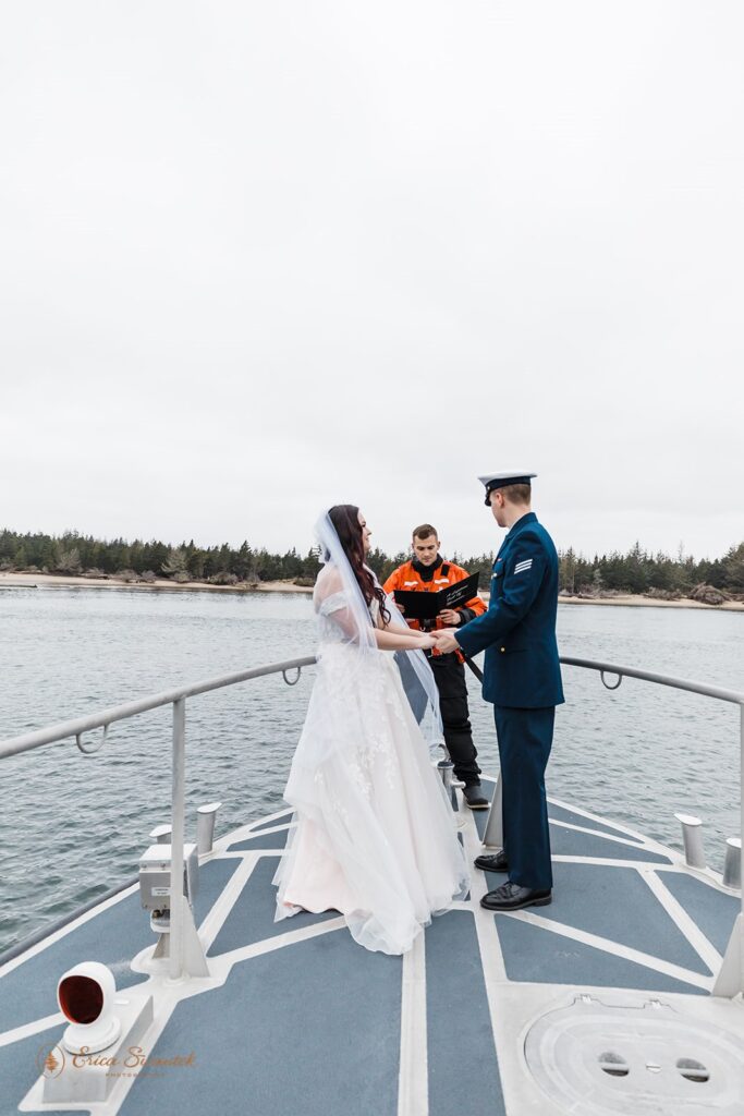A military couple celebrates their coastal elopement on a boat in Winchester Bay. 