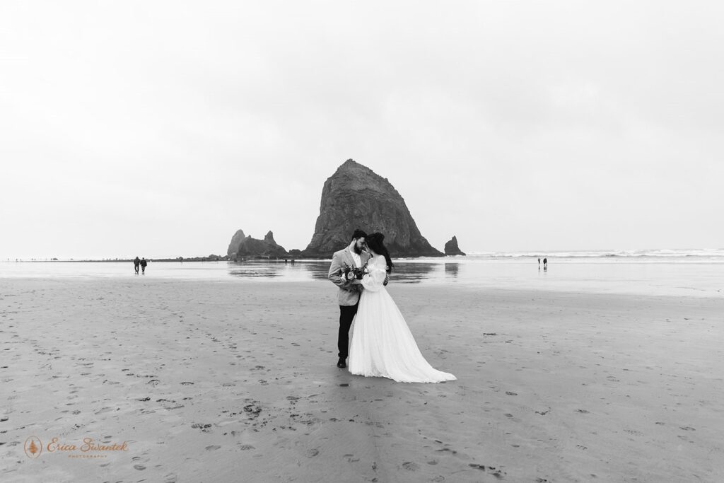 A couple elopes at Haystack Rock during low tide. 