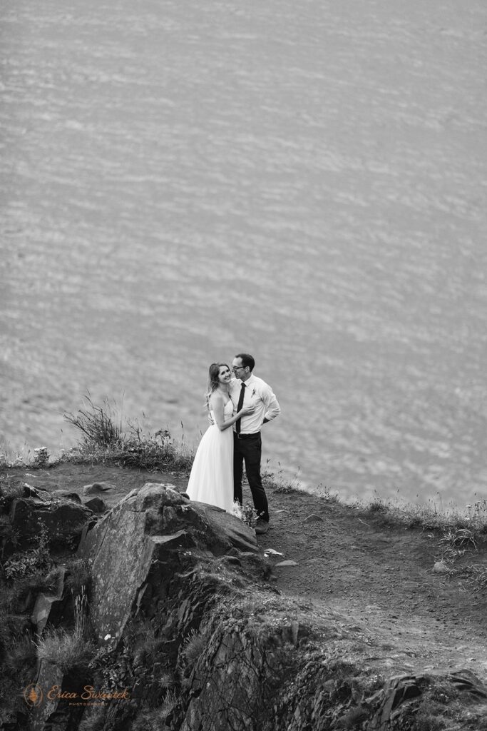 An elopement couple embraces during their intimate elopement along the Oregon Coast.