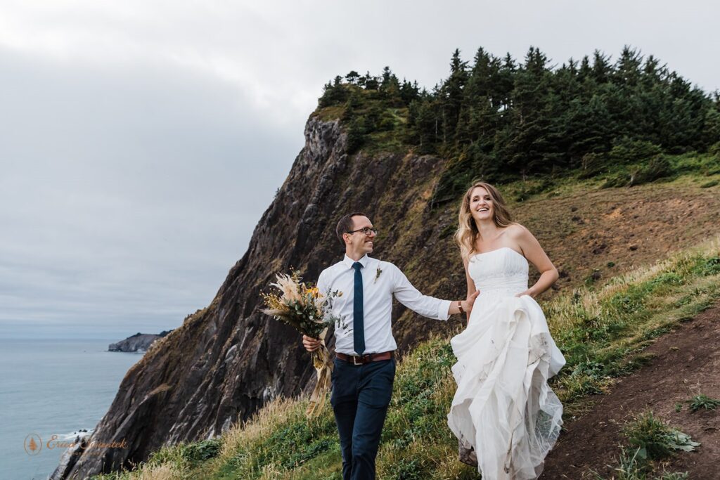 A couple hikes along Elk Flats Trail during their coastal elopement celebration in Oregon.