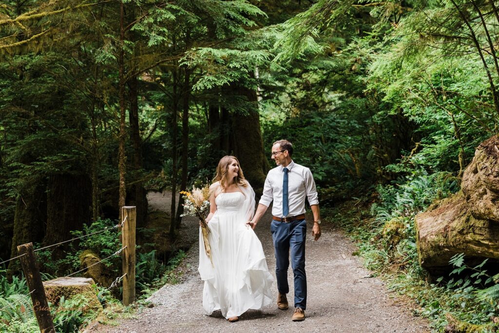 A bride and groom share a first look along a path down to Short Sand Beach, Oregon.