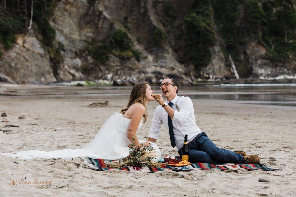A couple enjoys a picnic on a blanket at Short Sand Beach in Oregon.