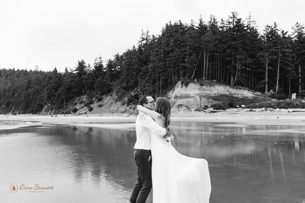A couple kisses after saying I Do on Short Sand Beach. 