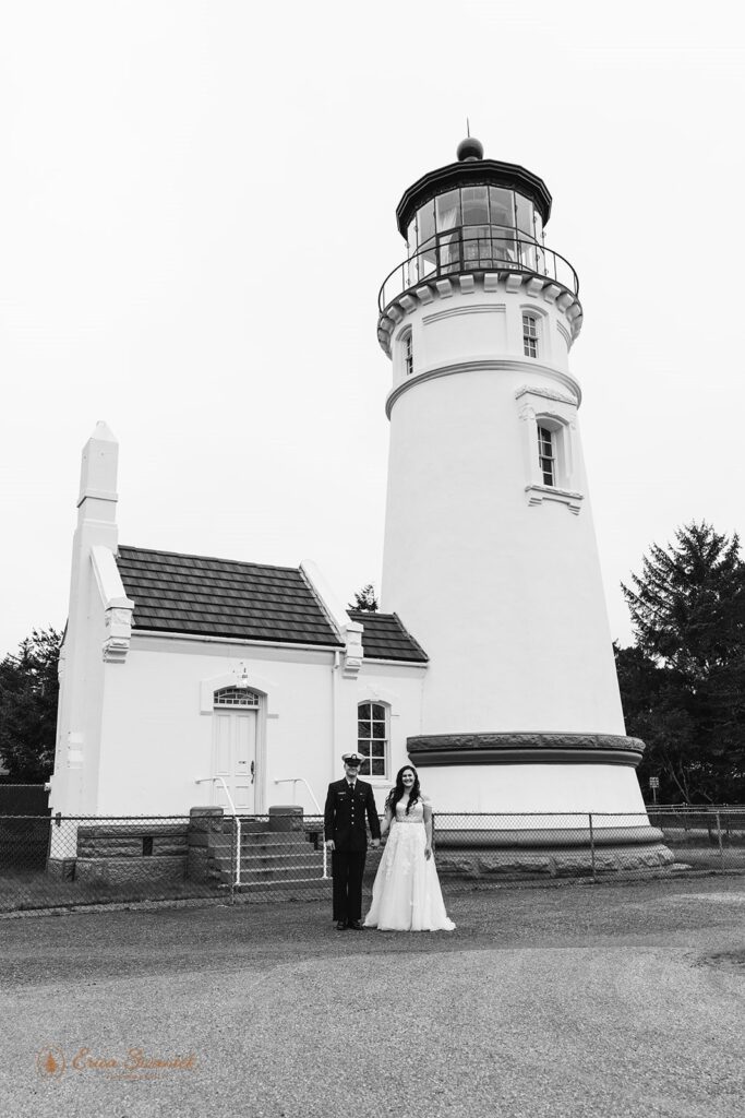 A military couple stands near Umpqua River Lighthouse along the Oregon Coast. 