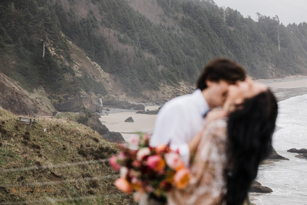 A couple embraces close during their Oregon Coast elopement at Ecola State Park. 