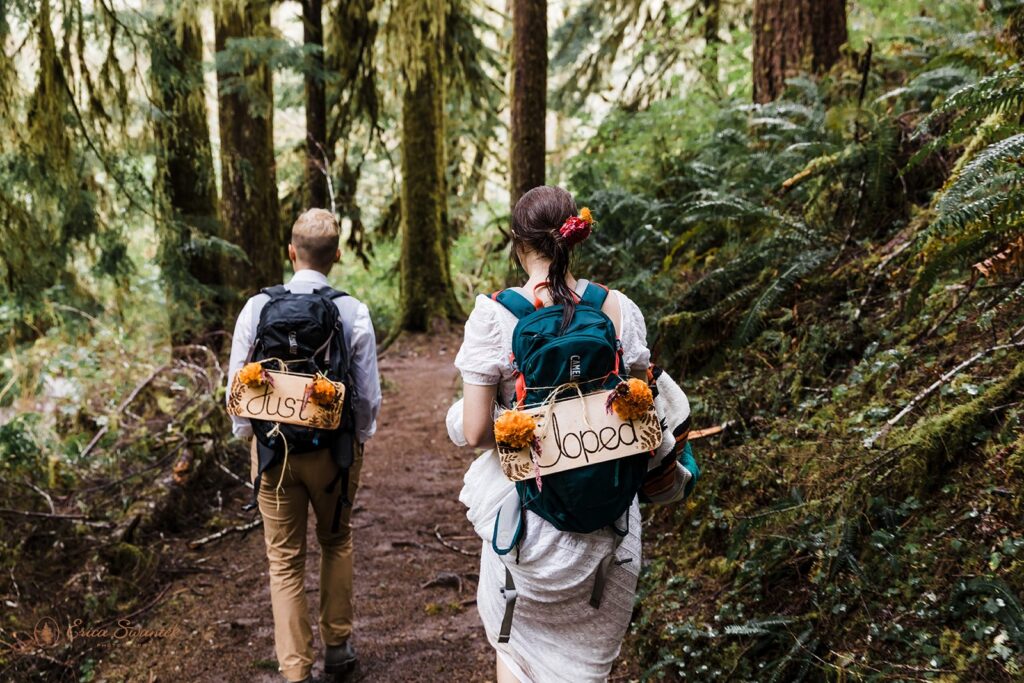 A hiking elopement couple walks along Drift Creek Falls Trailhead in Siuslaw National Forest. 