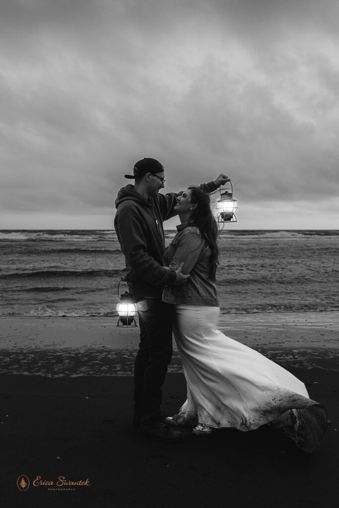 bride and groom posing with lanterns during their oregon coast elopement