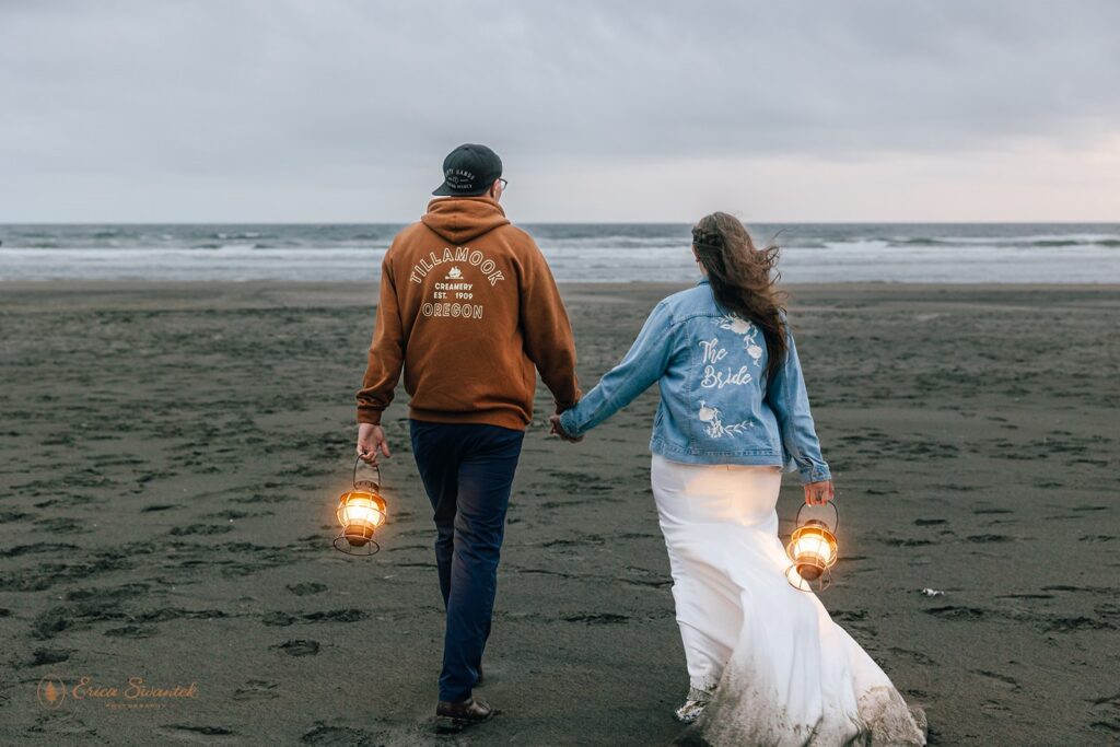bride and groom walking with lanterns during their oregon coast elopement