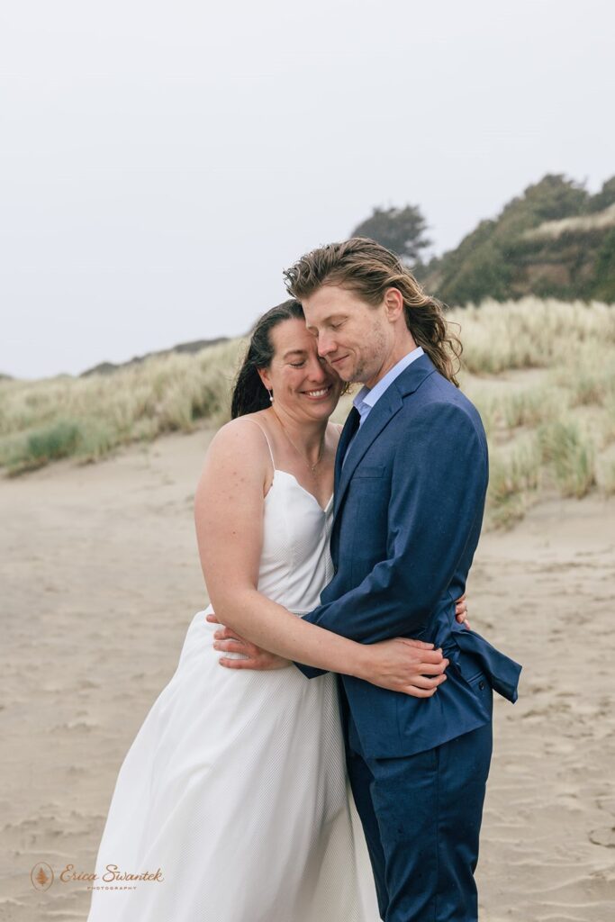 playful elopement couple at the beach in newport during their oregon coast elopement