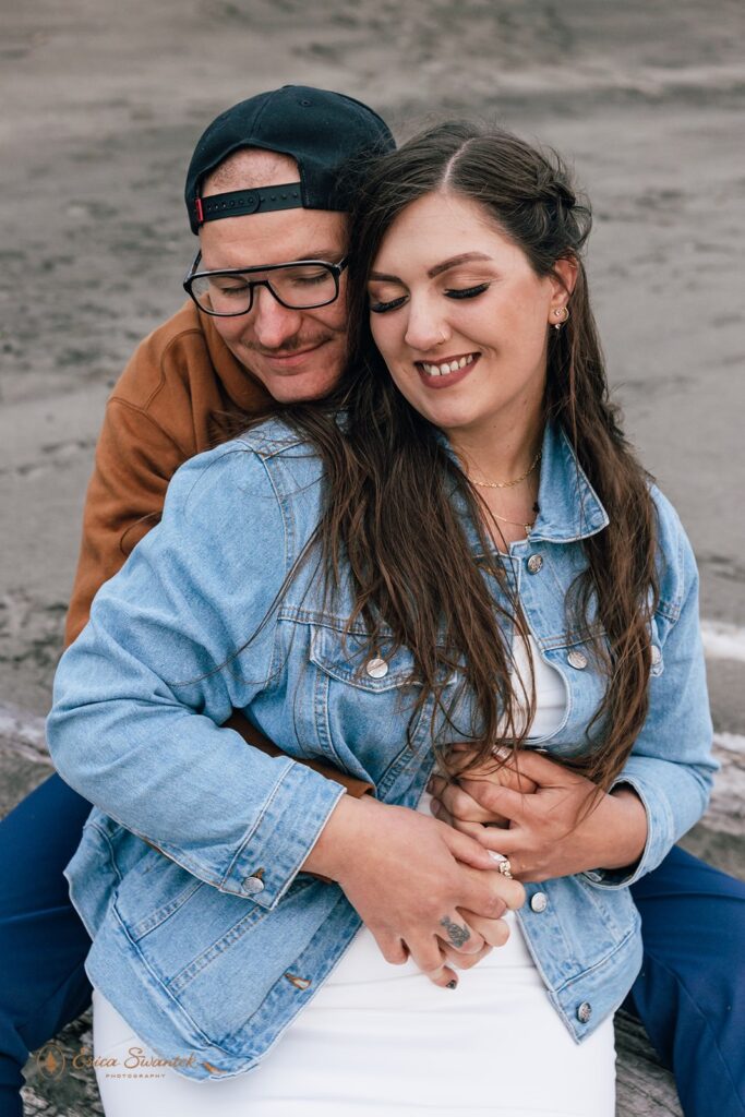 couple hugging during their oregon coast elopement at fort stevens