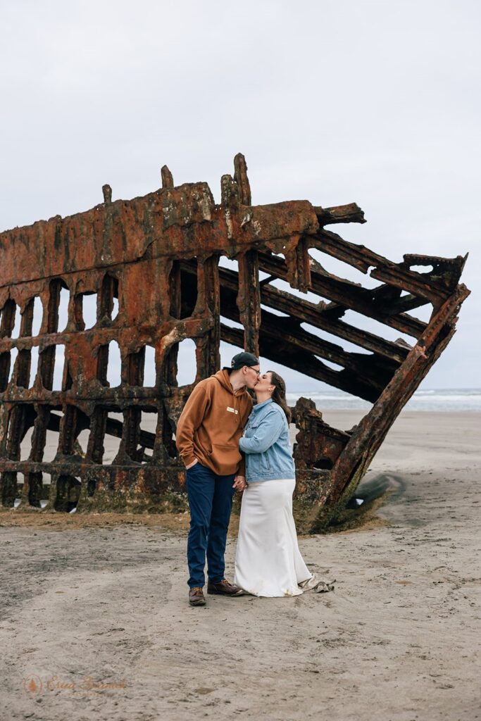 couple kissing during their oregon coast elopement at fort stevens