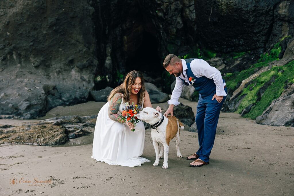 elopement couple cuddling their dog at the beach