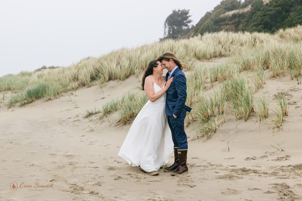 playful elopement couple at the beach in newport during their oregon coast elopement