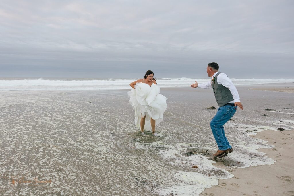 playful elopement couple during their beach elopement photoshoot in lincoln city
