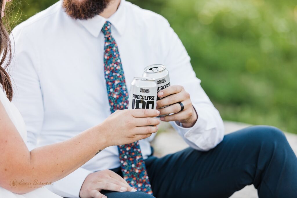 A couple toasts beer cans during their adventure elopement in Mt. Rainier National Park. 