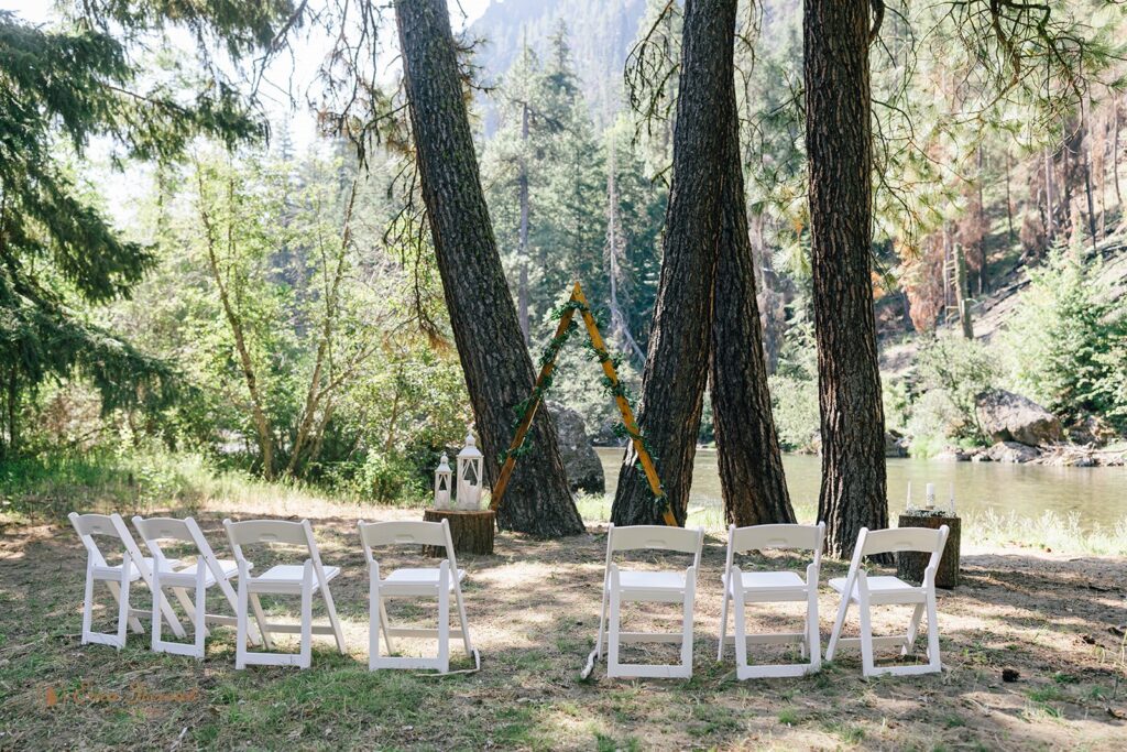 An intimate outdoor wedding ceremony set up near Naches River at Whistlin' Jack's. 