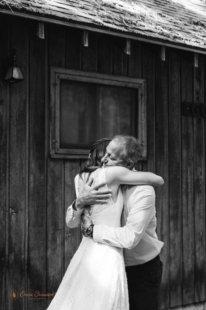 A bride embraces her father just before her Washington intimate wedding ceremony at Whistlin' Jack's. 