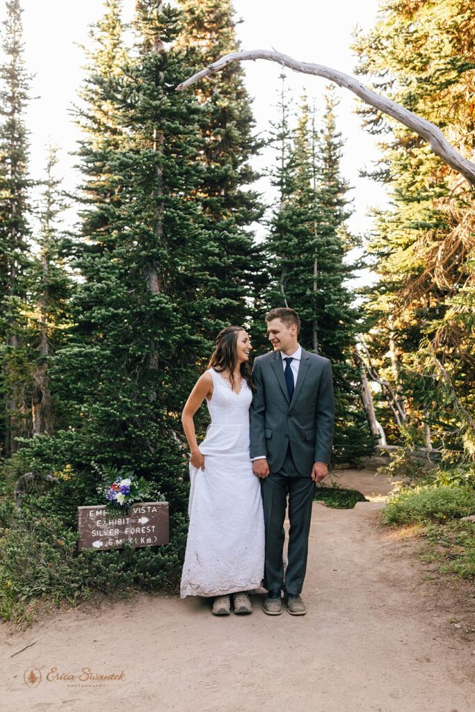 A couple shows off their hiking shoes while wearing traditional wedding attire during their National Park elopement. 