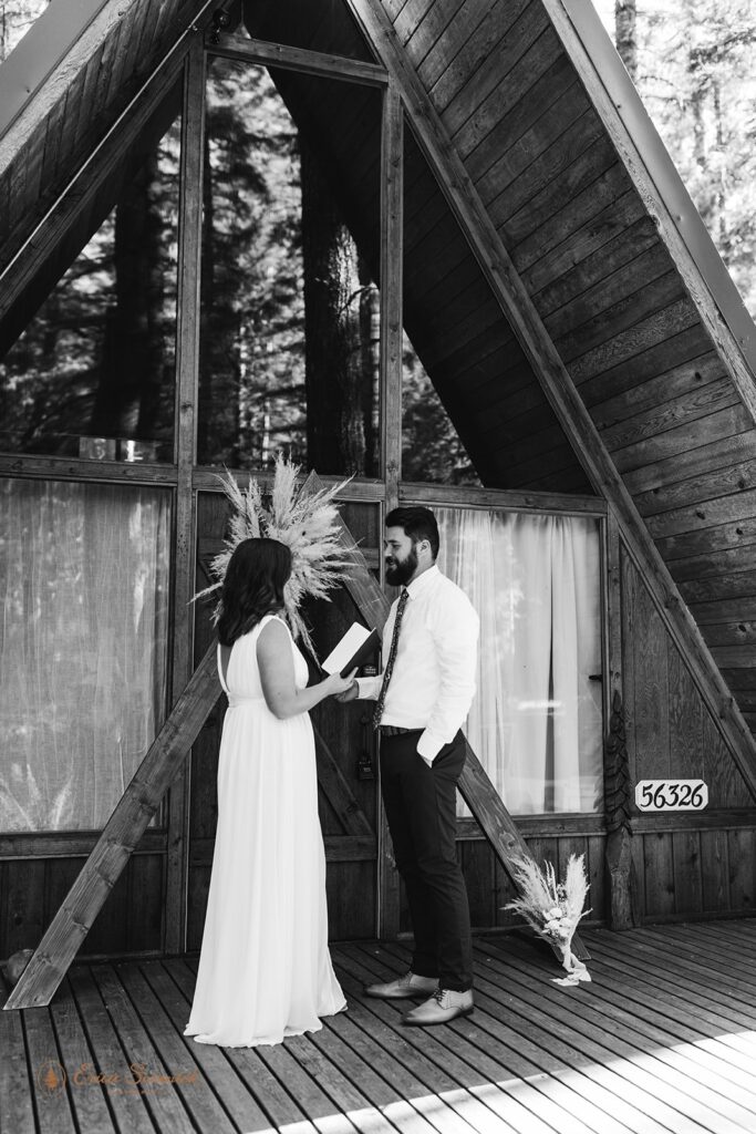 A couple recites intimate vows on the porch of a cabin near Mt. Rainier National Park. 