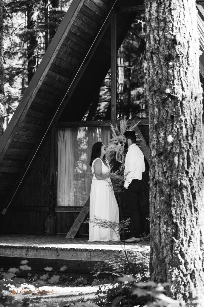 A couple shares laughter during their Washington Airbnb vow ceremony near Mt. Rainier National Park. 