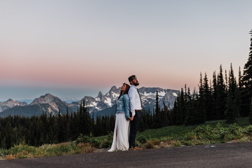 A newlywed couple holds hands during their Sunset elopement in Mt. Rainier National Park.