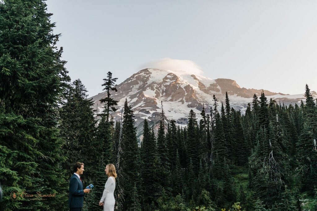 A couple recites intimate vows with Mt. Rainier in the background during their Washington elopement. 
