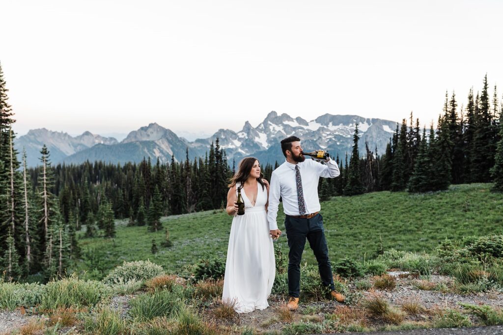 A newlywed couple celebrates their Sunset National Park elopement with a champagne toast in Mt. Rainier National Park. 
