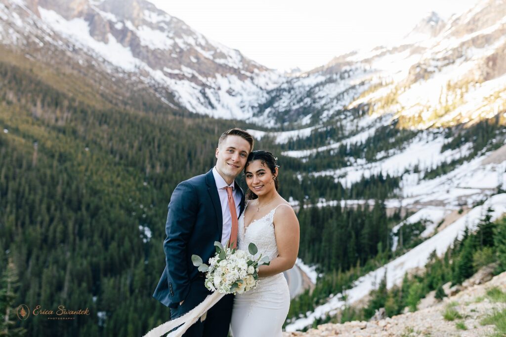 A couple posing for a wedding portrait during their North Cascades elopement at Washington Pass.