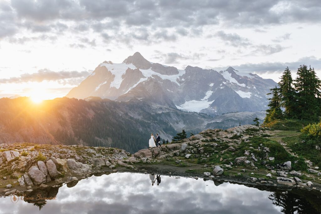 A Washington elopement couple walks along Artist Point trail during their ceremony at Sunrise. 