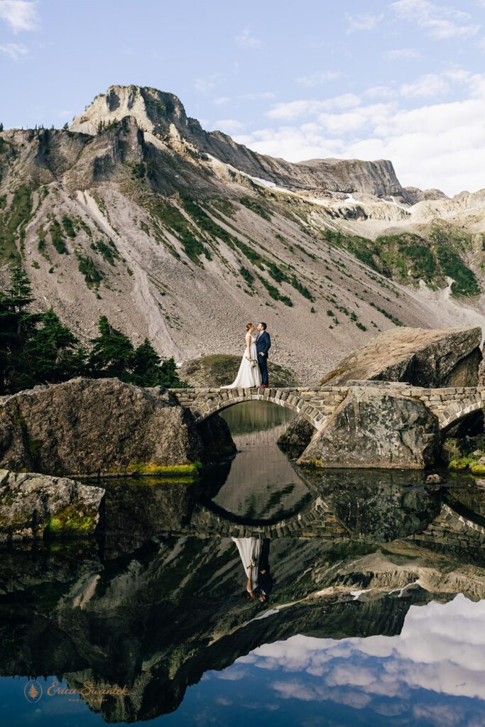 A North Cascades elopement couple walks along a bridge at Bagley Lakes in Washington. 