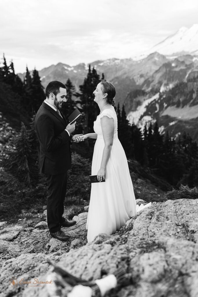 A North Cascades elopement couple recites vows during an intimate ceremony with snowy Mt. Baker in the distance.