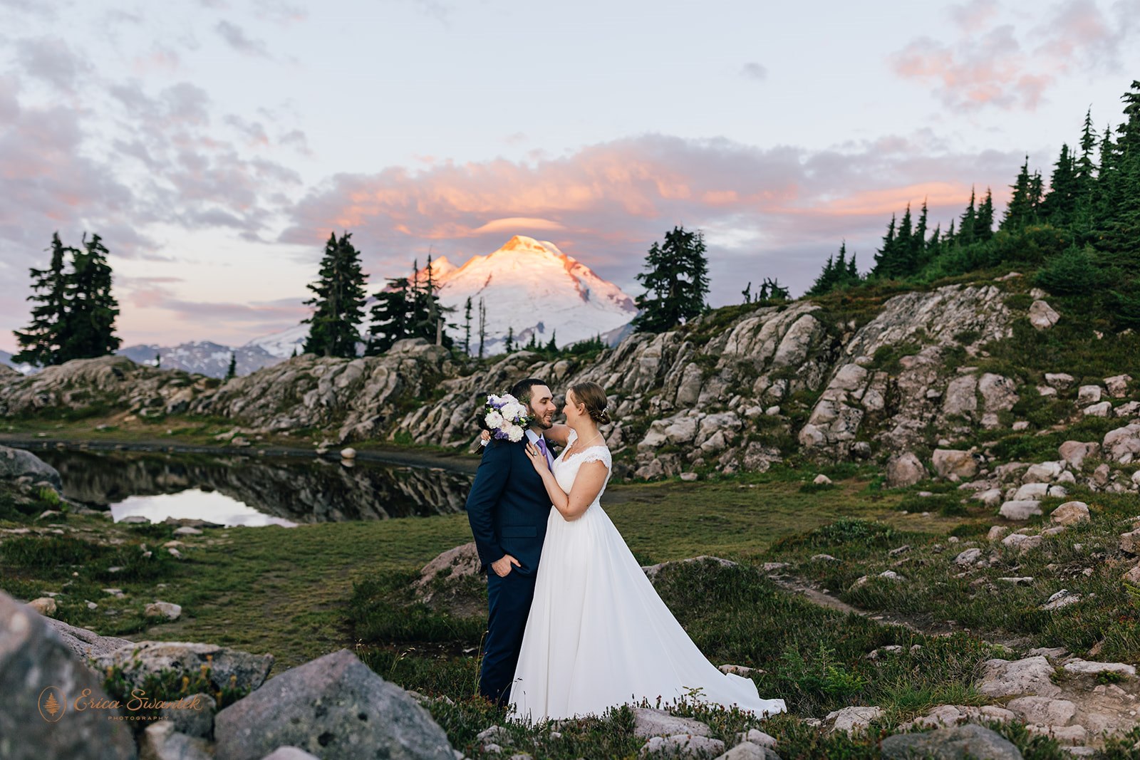 An Artist Point elopement couple embraces during Sunrise in front of Mt. Baker.