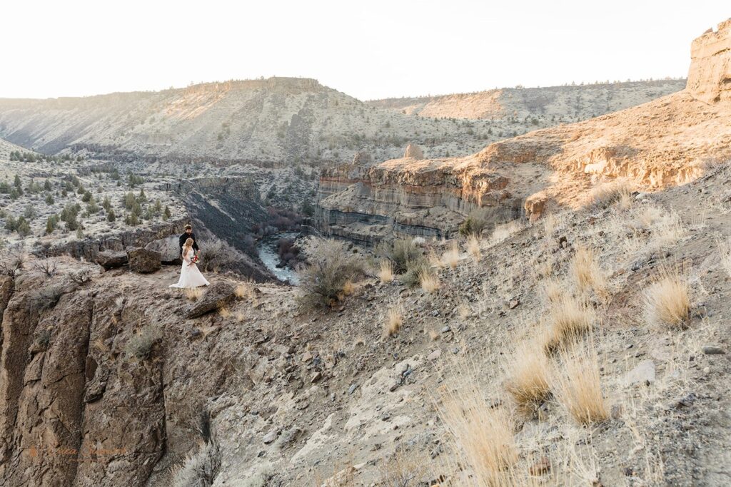 An adventure elopement couple hike along a ridge at Desert Canyon near Bend, Oregon. 