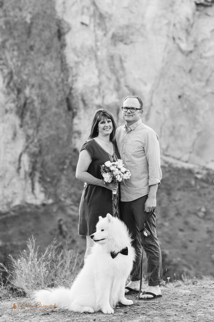 An Oregon elopement couple pose for a portrait at Smith Rock State Park, a dog-friendly elopement locations