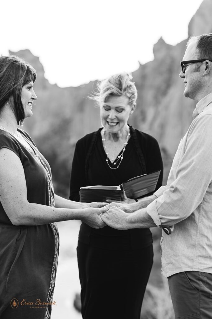An Oregon officiant guides a couple's vow ceremony at Smith Rock State Park. 