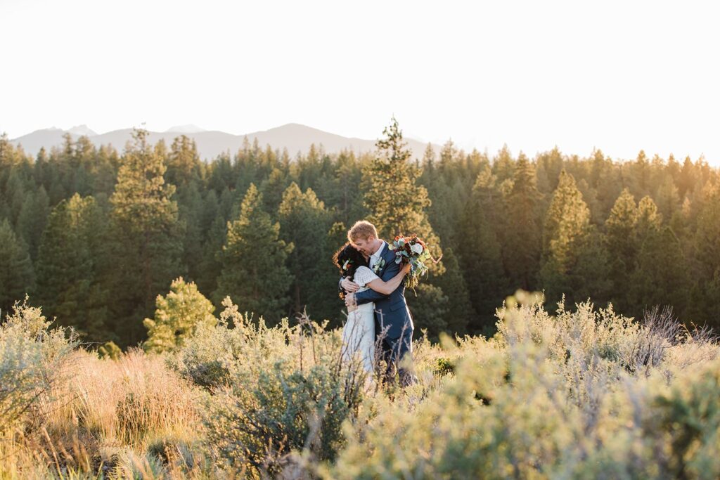 A bride and groom embrace at golden hour during their elopement at Shevlin Park, an intimate Bend wedding location. 