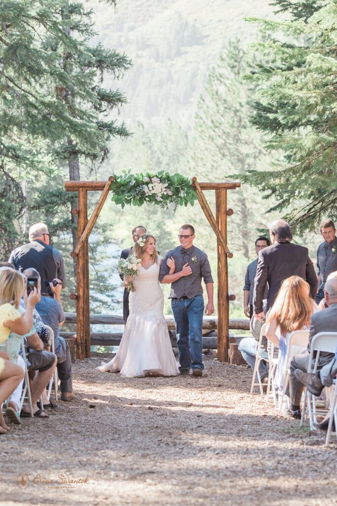 An Oregon intimate wedding couple walks down the aislfe after their ceremony at Skyliner's Lodge near Bend, Oregon. 