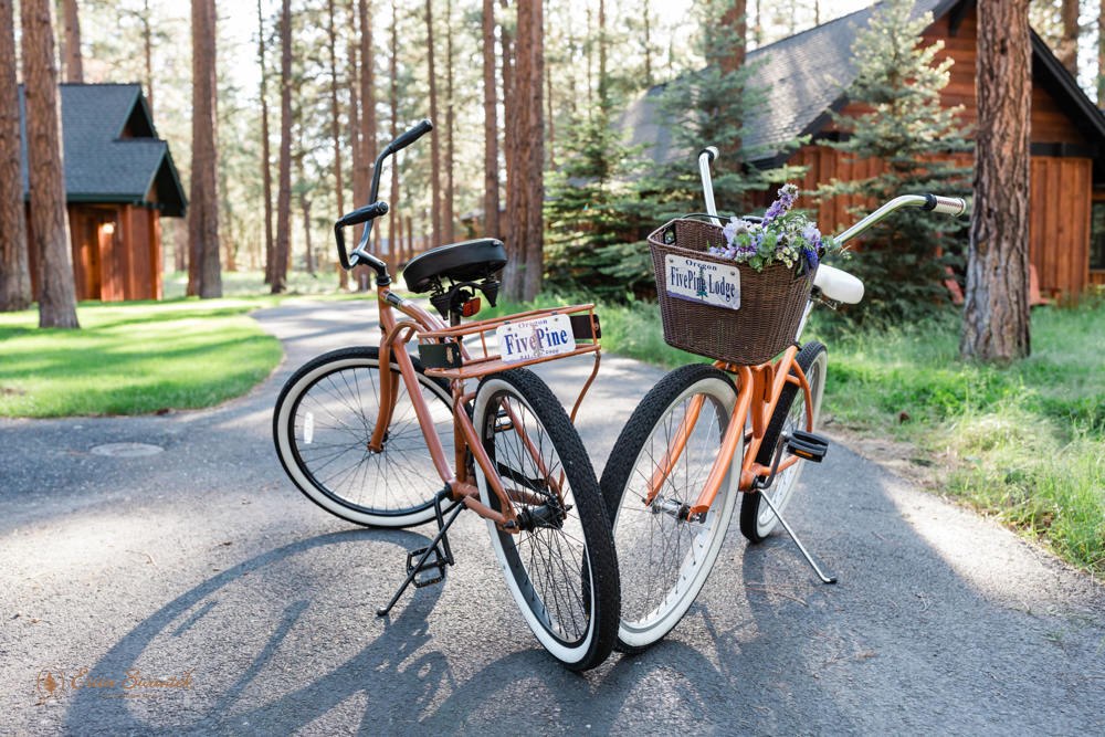 Two bikes parked along a sidewalk at FivePine Lodge, a wedding location in Bend, Oregon. 