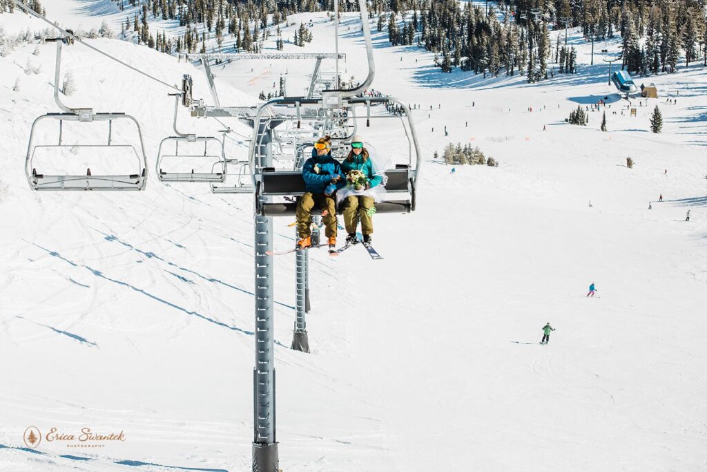 A ski elopement couple ride on a chairlift at Mt. Bachelor. 