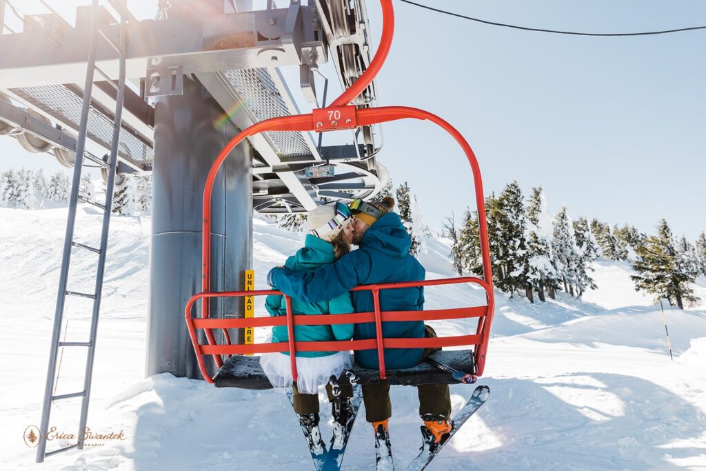 A ski elopement couple kiss on a chairlift at Mt. Bachelor. 