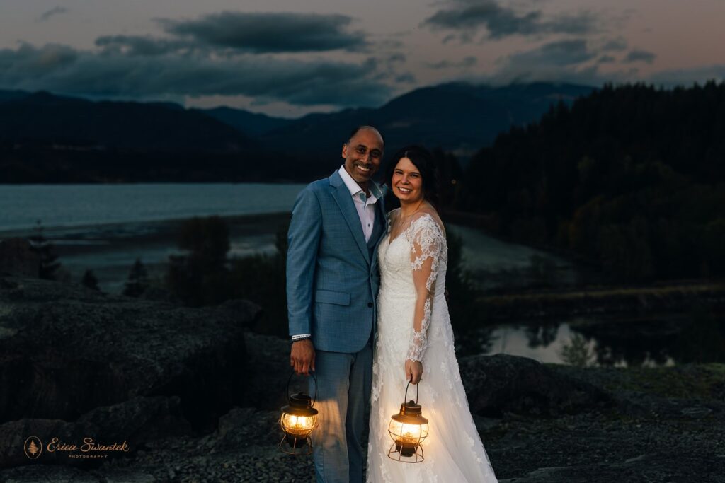 bride and groom walking around with lanterns at government cove