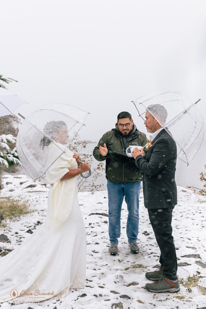 couple sharing a kiss after the winter elopement ceremony in Columbia River Gorge surrounded by snowy scenery