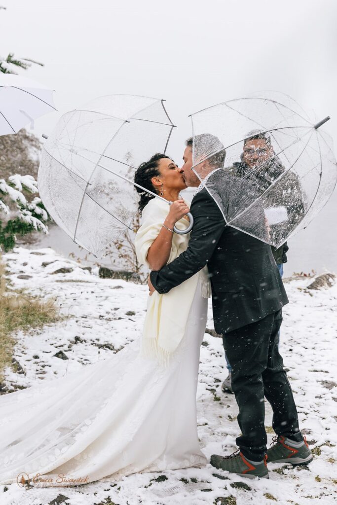 couple sharing a kiss after the winter elopement ceremony in Columbia River Gorge surrounded by snowy scenery