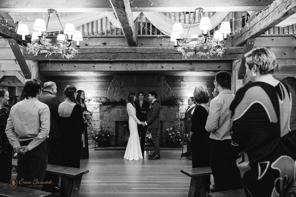 black and white wedding ceremony photo of bride and groom exchanging vows