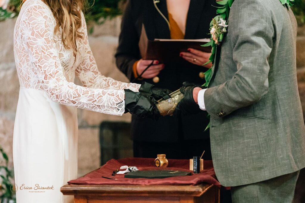 bride and groom performing a kitsungi unity ceremony during their cabin wedding day